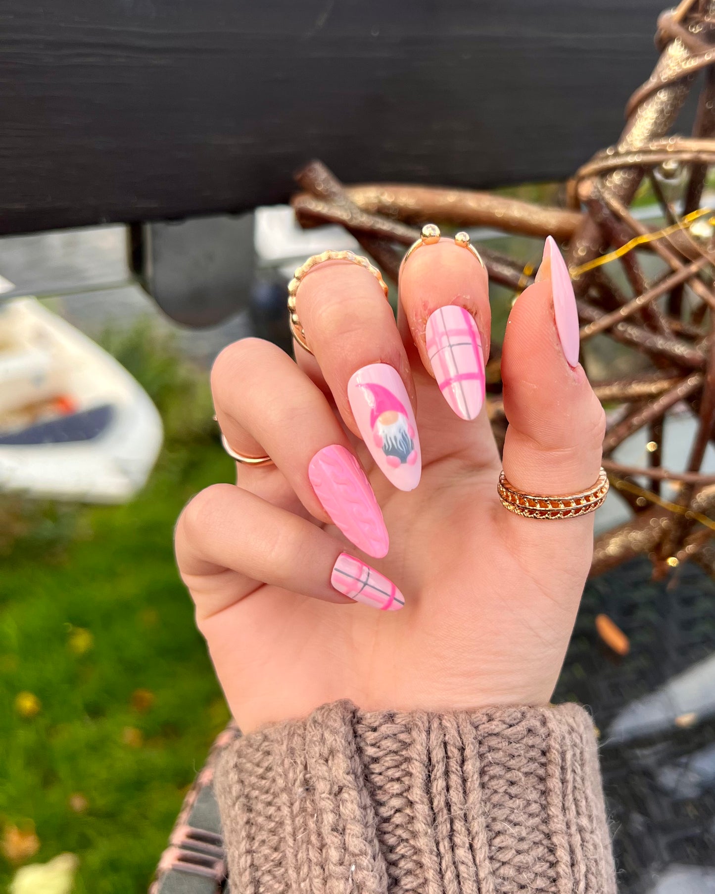Pink tartan sweater plaid knit gonk press on nails in almond shape.