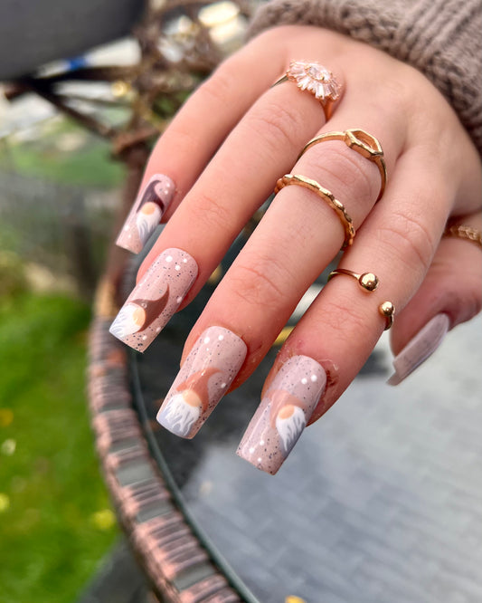 Dotted brown background fake nails with little gonks on each. Perfect cheap Christmas re-usable press on nails.