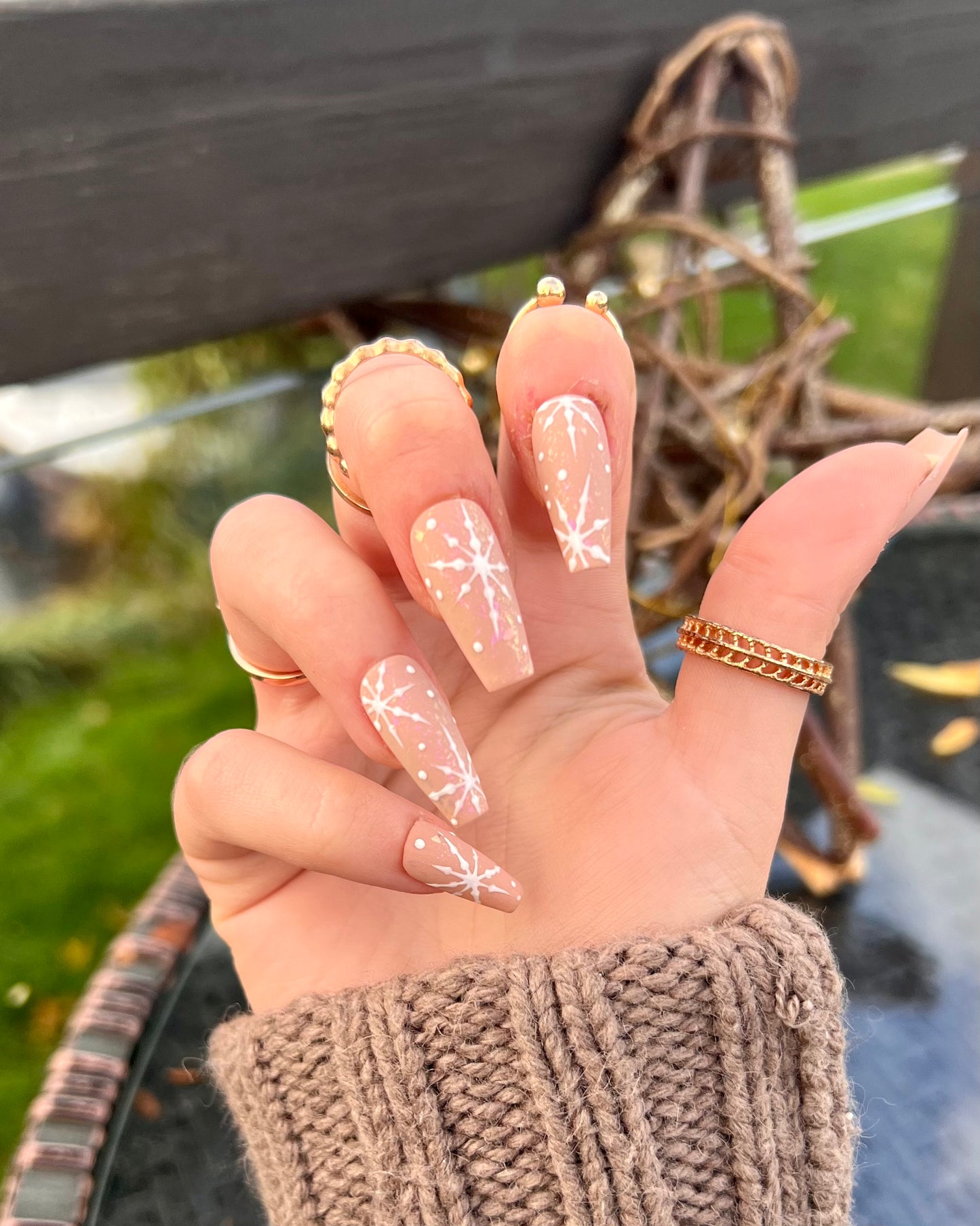 Mid-length coffin press on nails with a matte finish over some opal sparkles. Little shiny white snowflakes over the top for christmas winter nails.